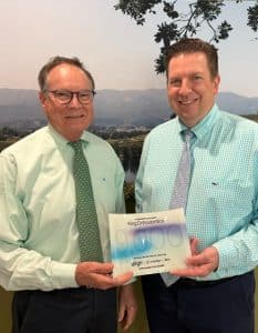Drs Earle and Bryan King pose with their Lifetime Achievement Award for 9000 patients treated with Invisalign® | King Orthodontics Drs-Earle-and-Bryan-King-pose-with-their-Lifetime-Achievement-Award-for-9000-patients-treated-with-Invisalign